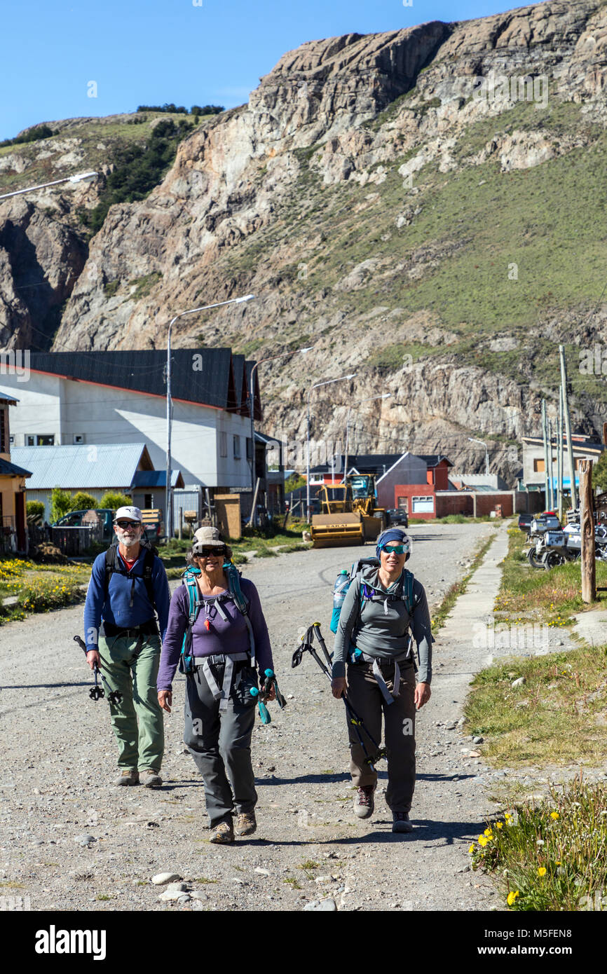 American trekkers return from a day of hiking; small mountain village of El Chalten; jumping off point to Cerro Torre and Cerro Fitz Roy; Patagonia; Stock Photo