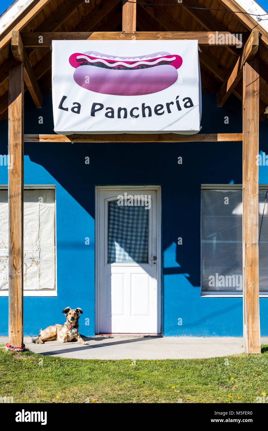 Restaurant facade & dog; small mountain village of El Chalten; jumping off point to Cerro Torre and Cerro Fitz Roy; Patagonia; Argentina Stock Photo