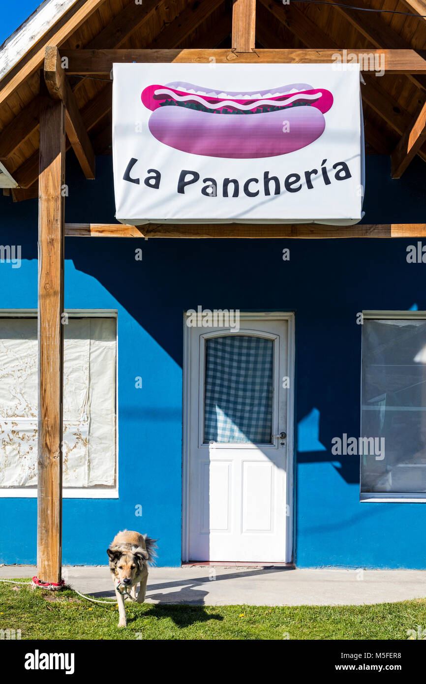 Restaurant facade & dog; small mountain village of El Chalten; jumping off point to Cerro Torre and Cerro Fitz Roy; Patagonia; Argentina Stock Photo