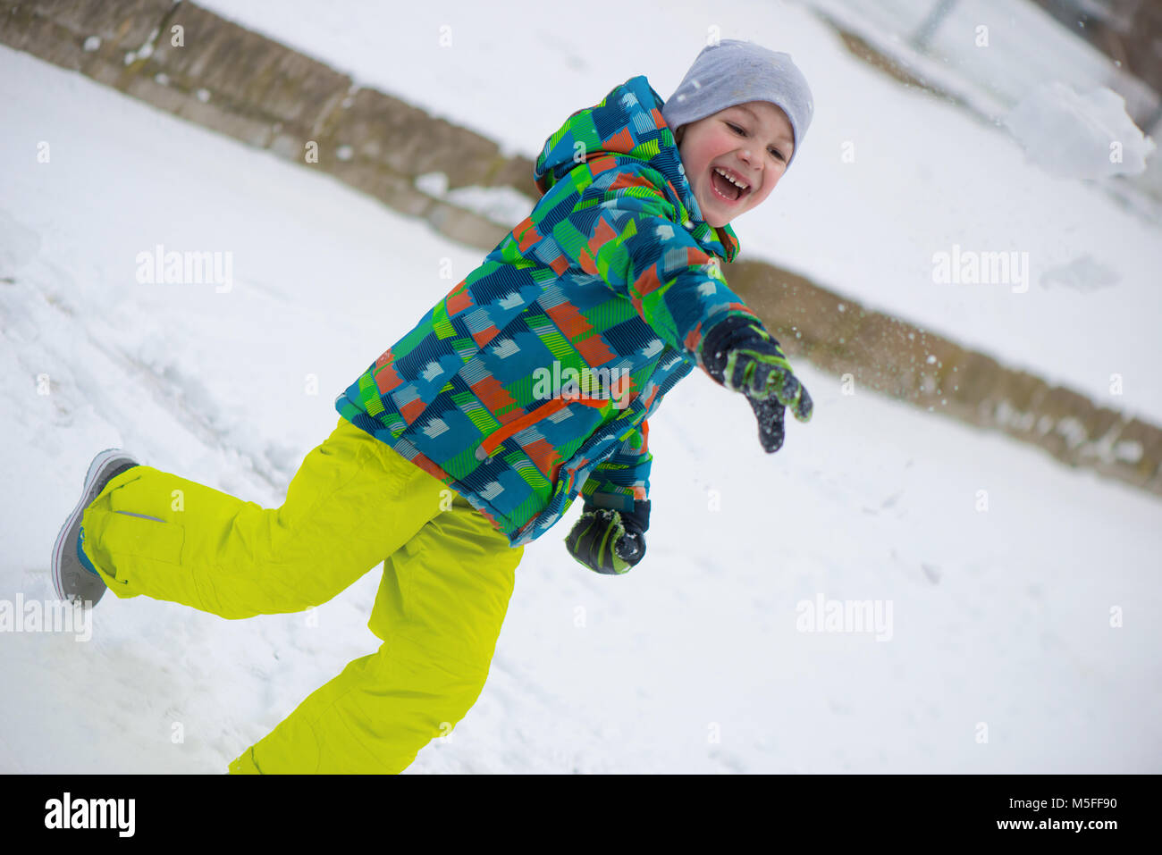 Children throwing snowballs in snowy winter park Stock Photo Alamy