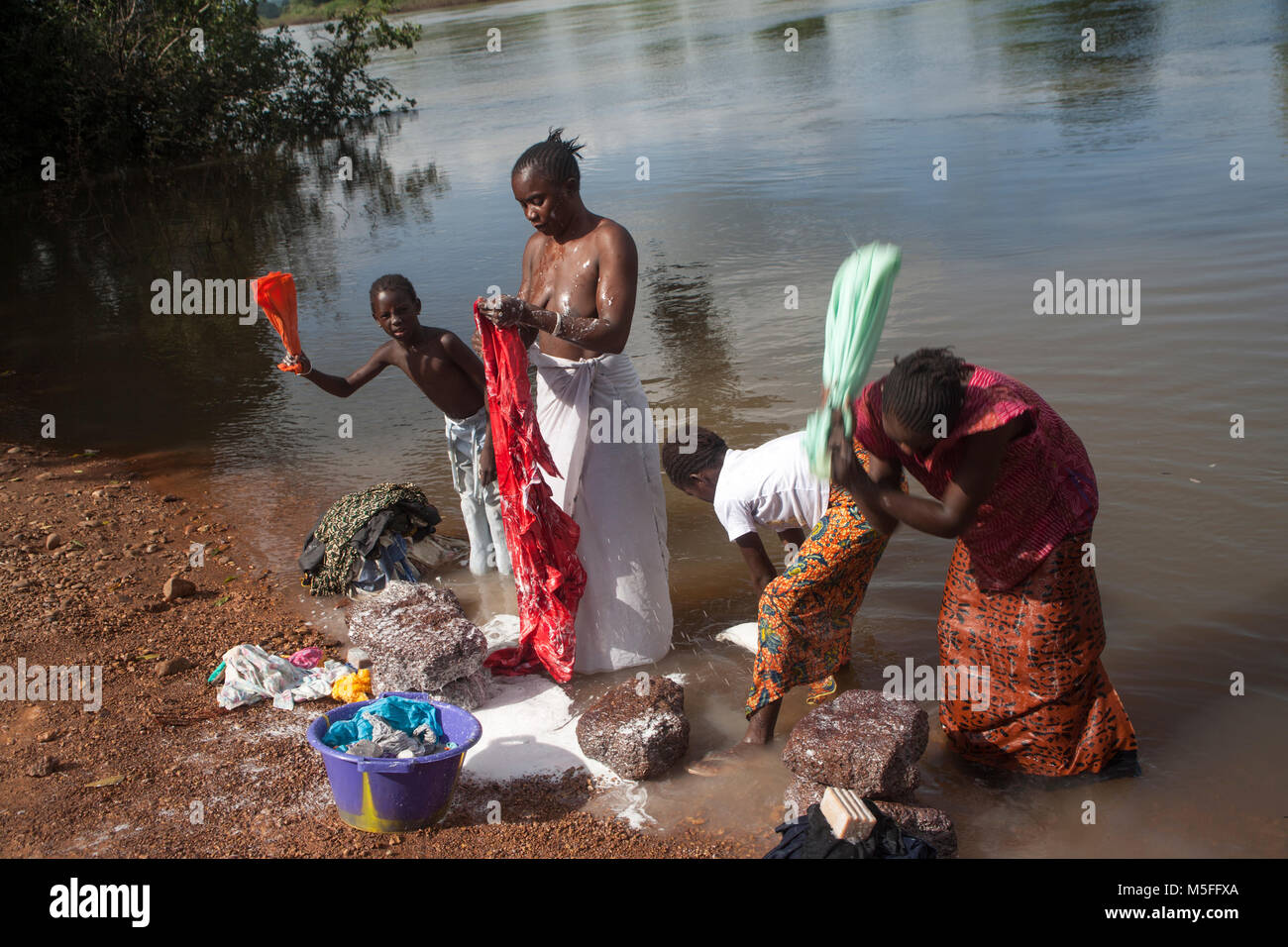 Village women wash in local river Stock Photo