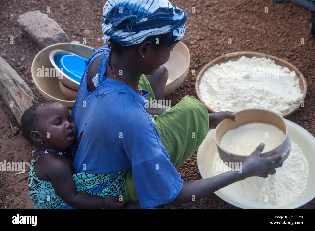 Woman is cooking in Kedougou village in Senegal, Africa Stock Photo
