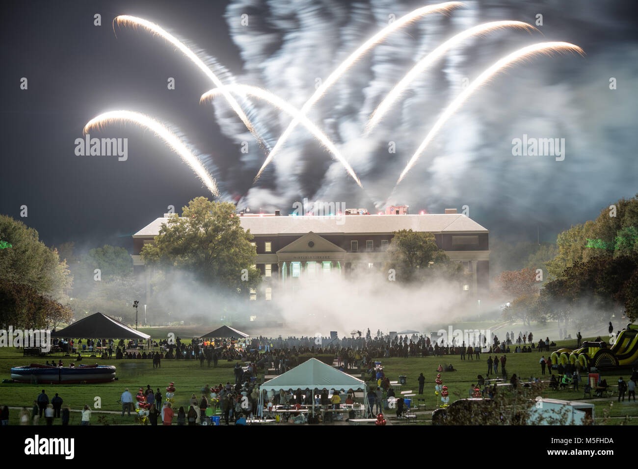 Crowd watches as firework specular goes off from McKeldin Library at