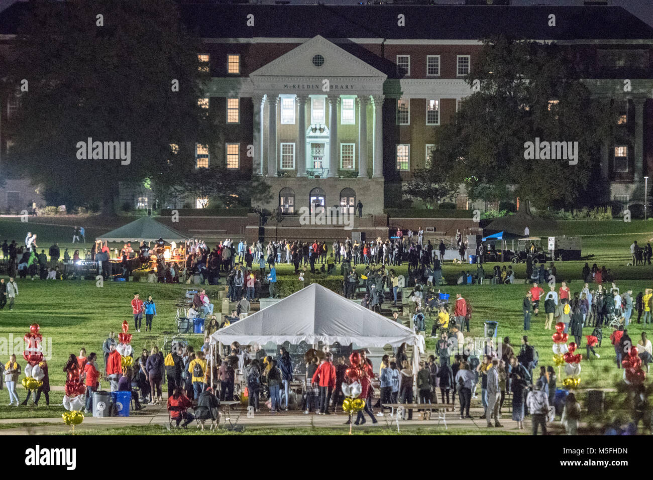 Crowd walks around on lawn in front McKeldin Library at University of