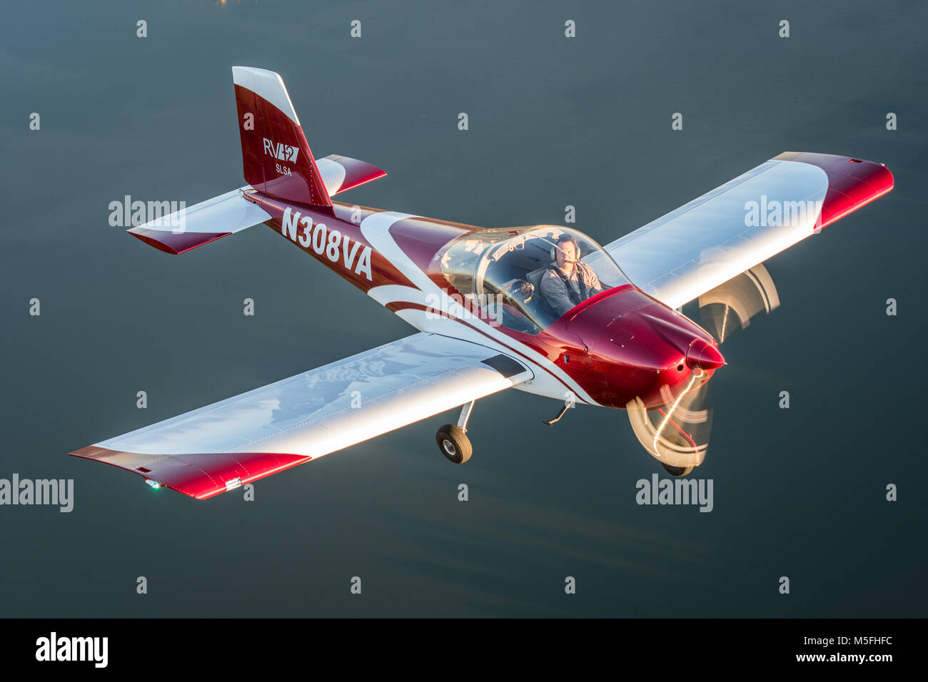 Male pilot operating blue Vans RV-12 light sport aircraft with female ...