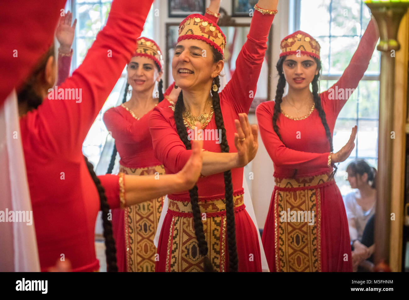 View in mirror of older Armenian woman instructing dancers on movement behind her, Washington Grove, Maryland. Stock Photo