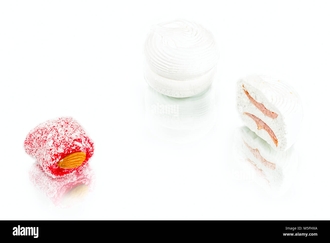 soft sweet marshmallows with  apricot jam inside and rakhat-lukum on white background, turkish sweets Stock Photo