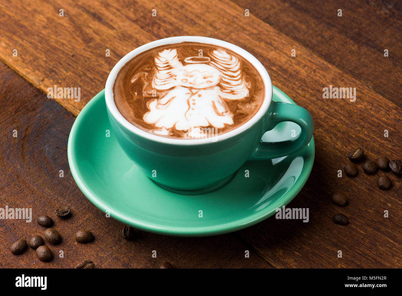 A Cup of hot latte art coffee on wooden table Stock Photo - Alamy