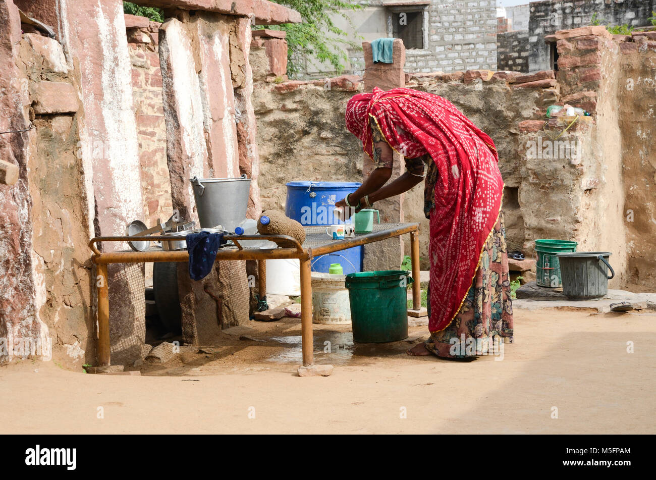 rajasthani woman washing cups, Jodhpur, Rajasthan, India, Asia Stock Photo