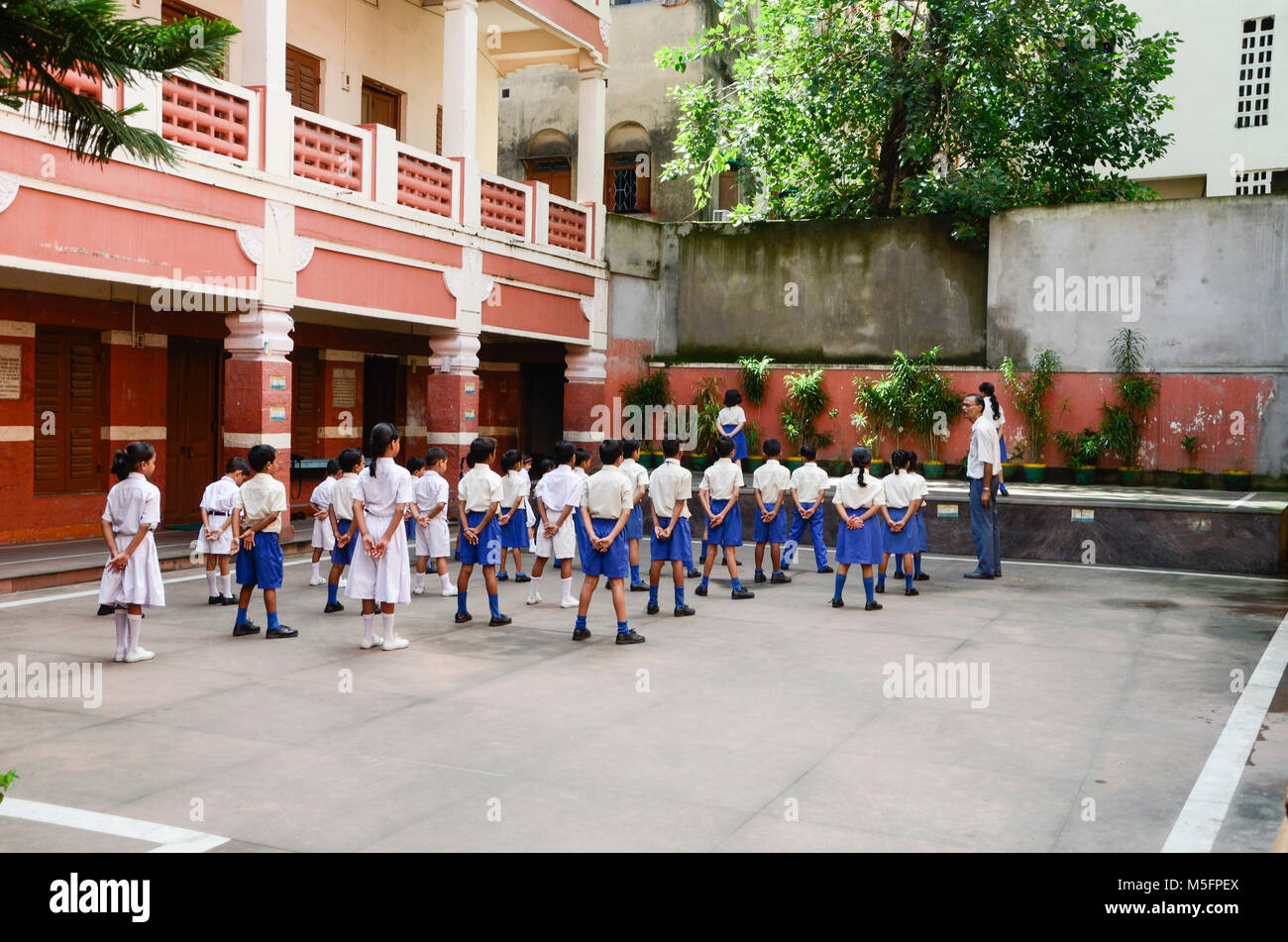 Boys and girls exercise in school compound, Kolkata, West Bengal, India, Asia Stock Photo