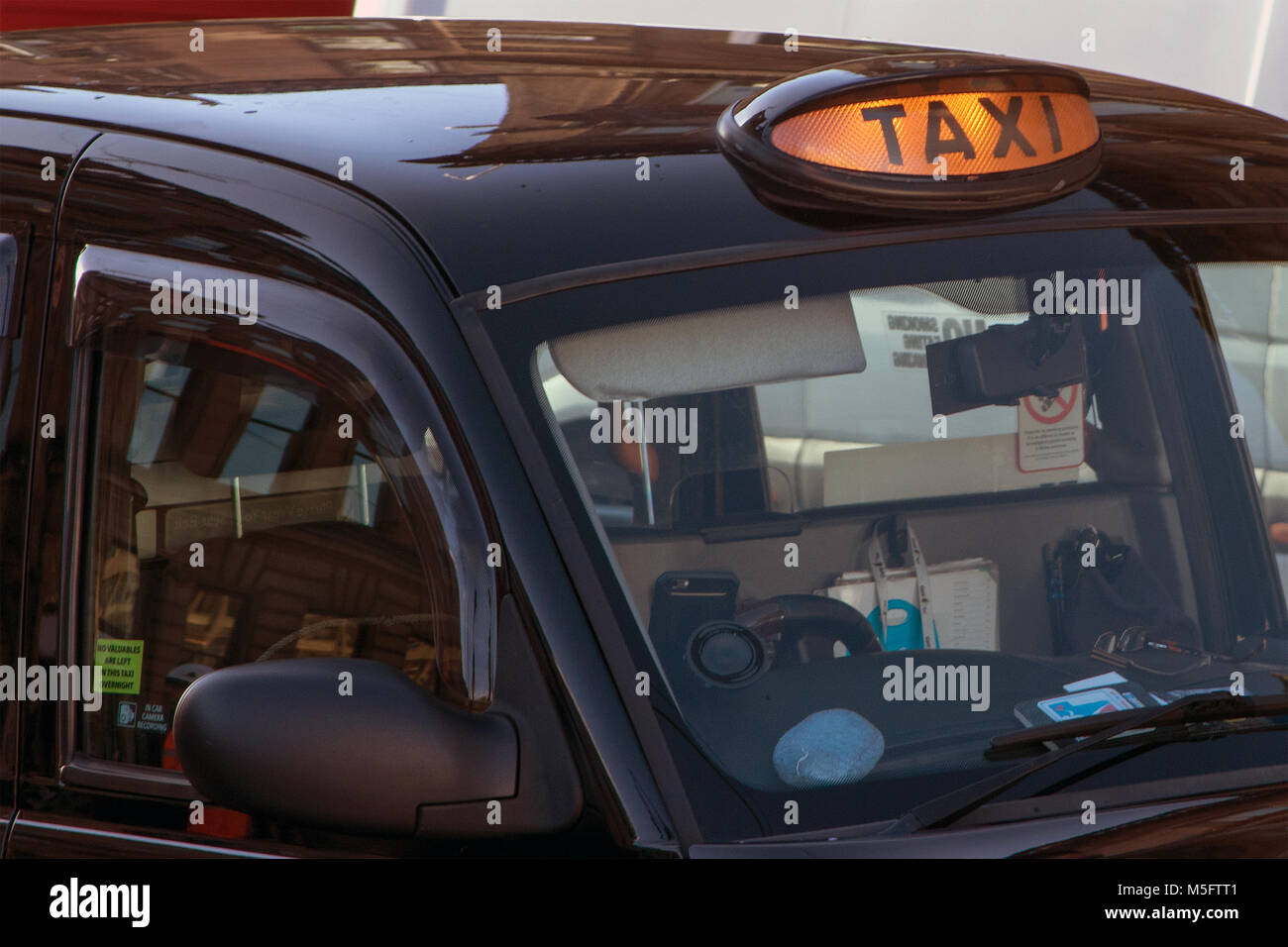 Taxi with roof light illuminated, Glasgow, Scotland Stock Photo