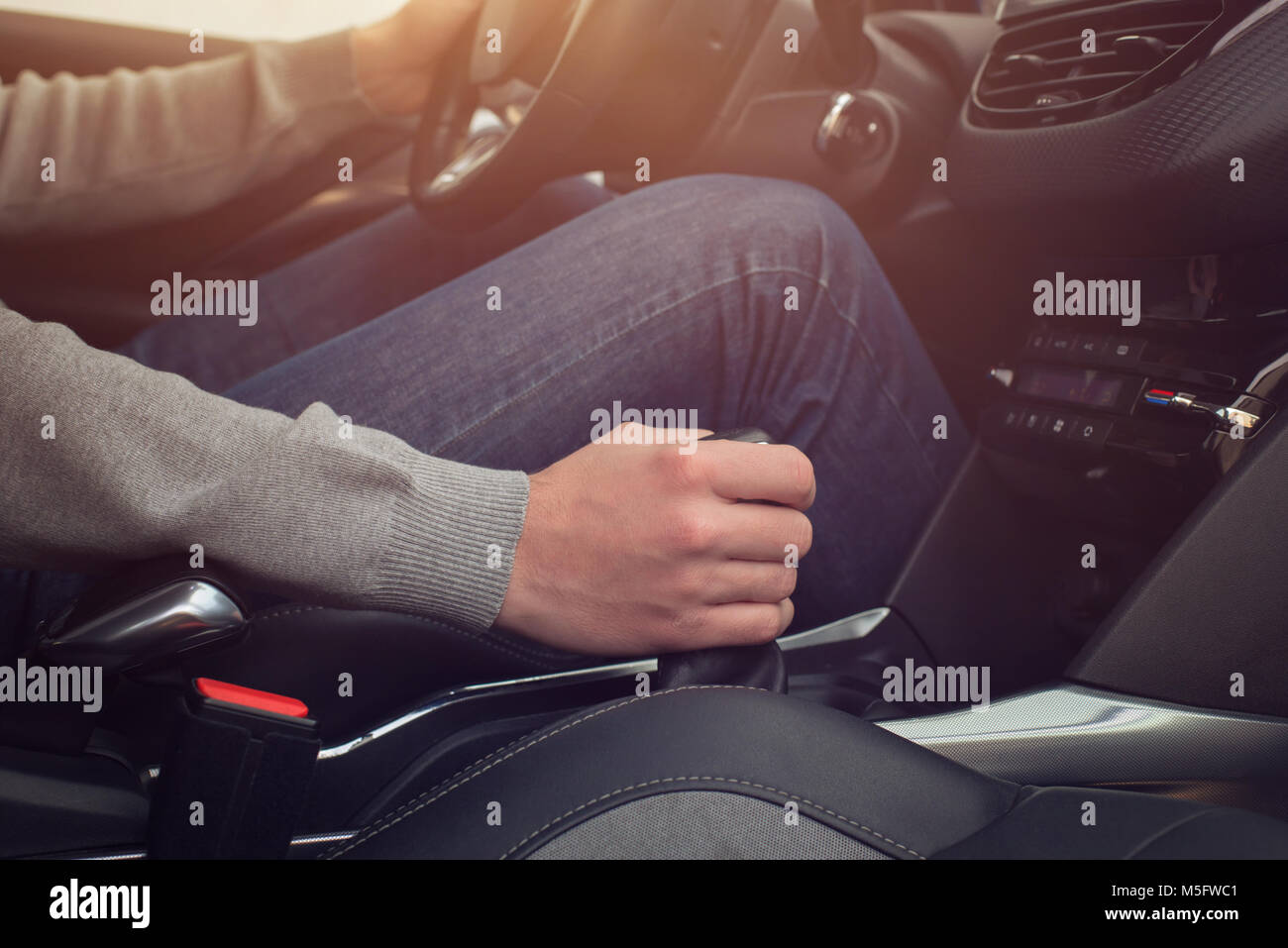 Switching the car speed with the gearbox. Modern car interior. Stock Photo