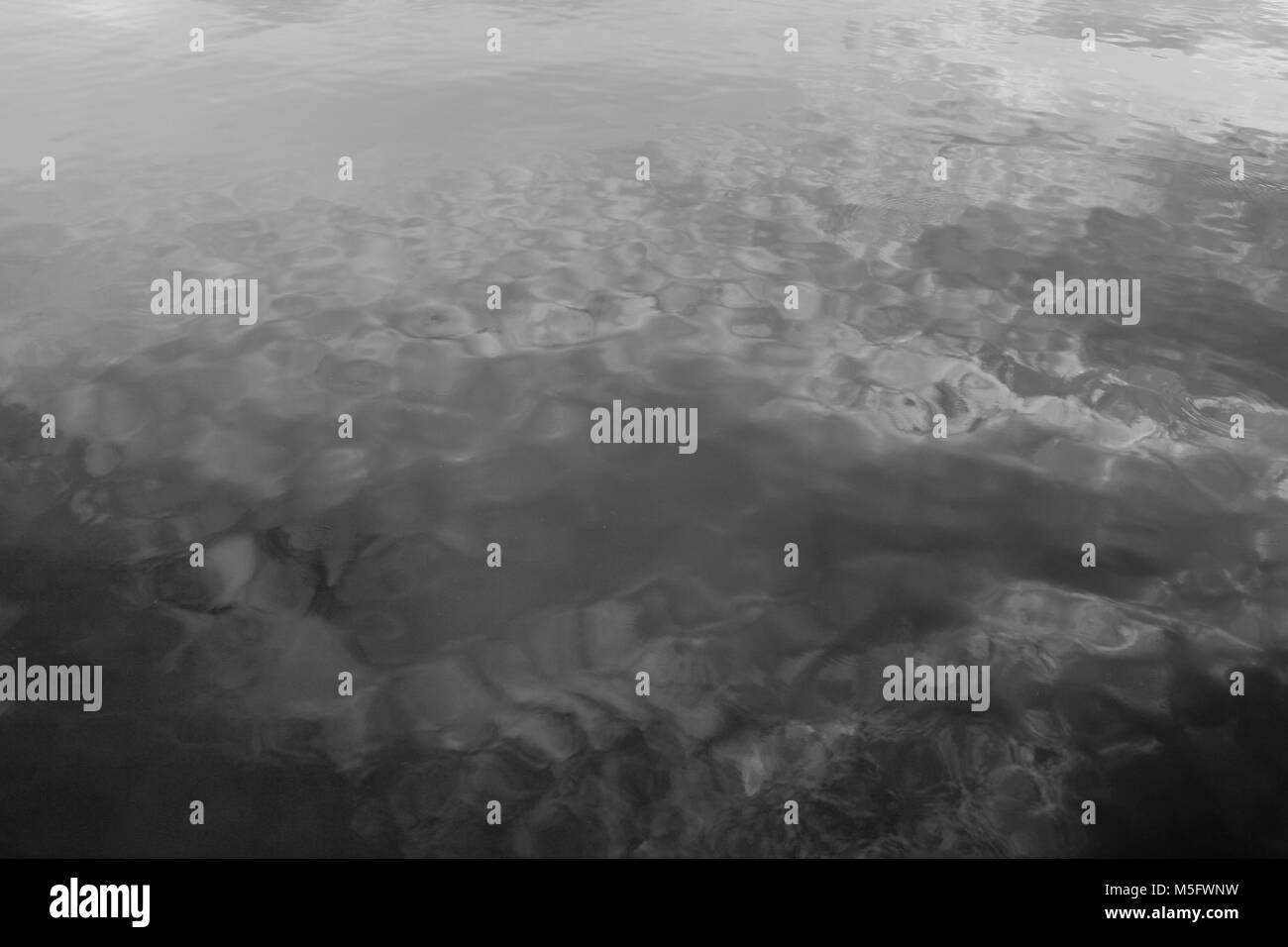 Water ripples with reflections of the sky and clouds Stock Photo - Alamy