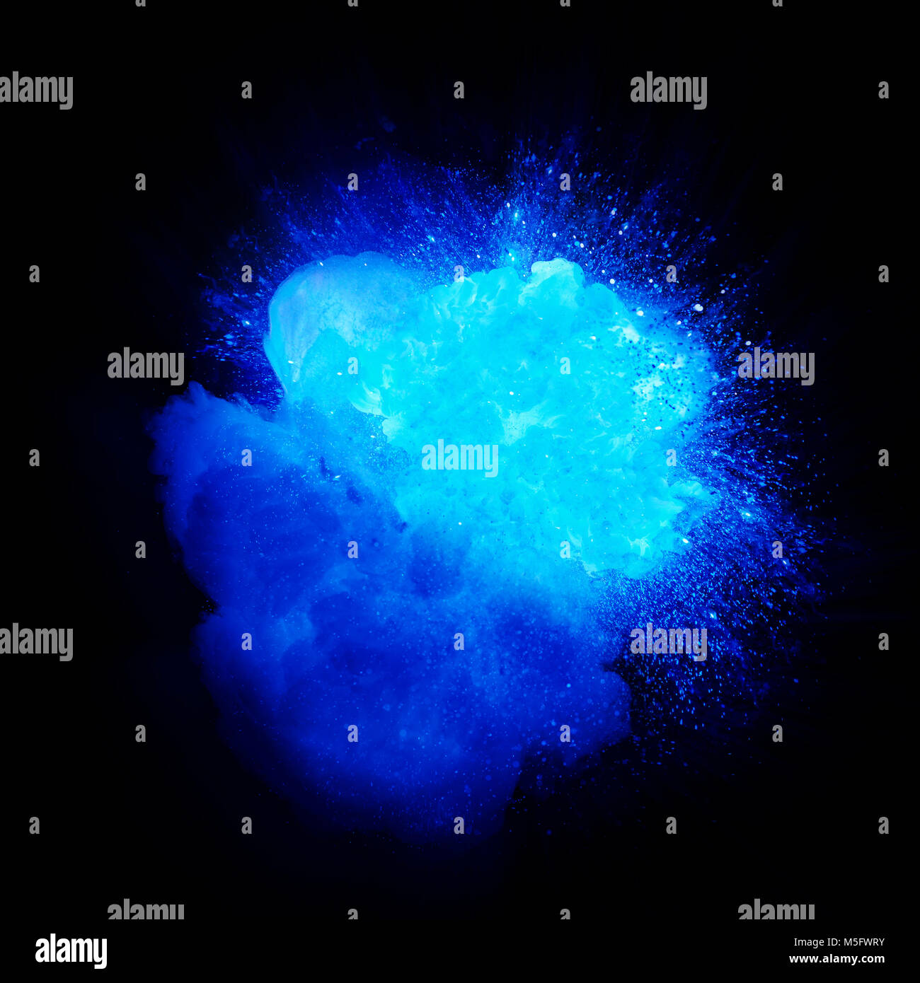 Blue fire explosion with sparks and smoke isolated on black background Stock Photo