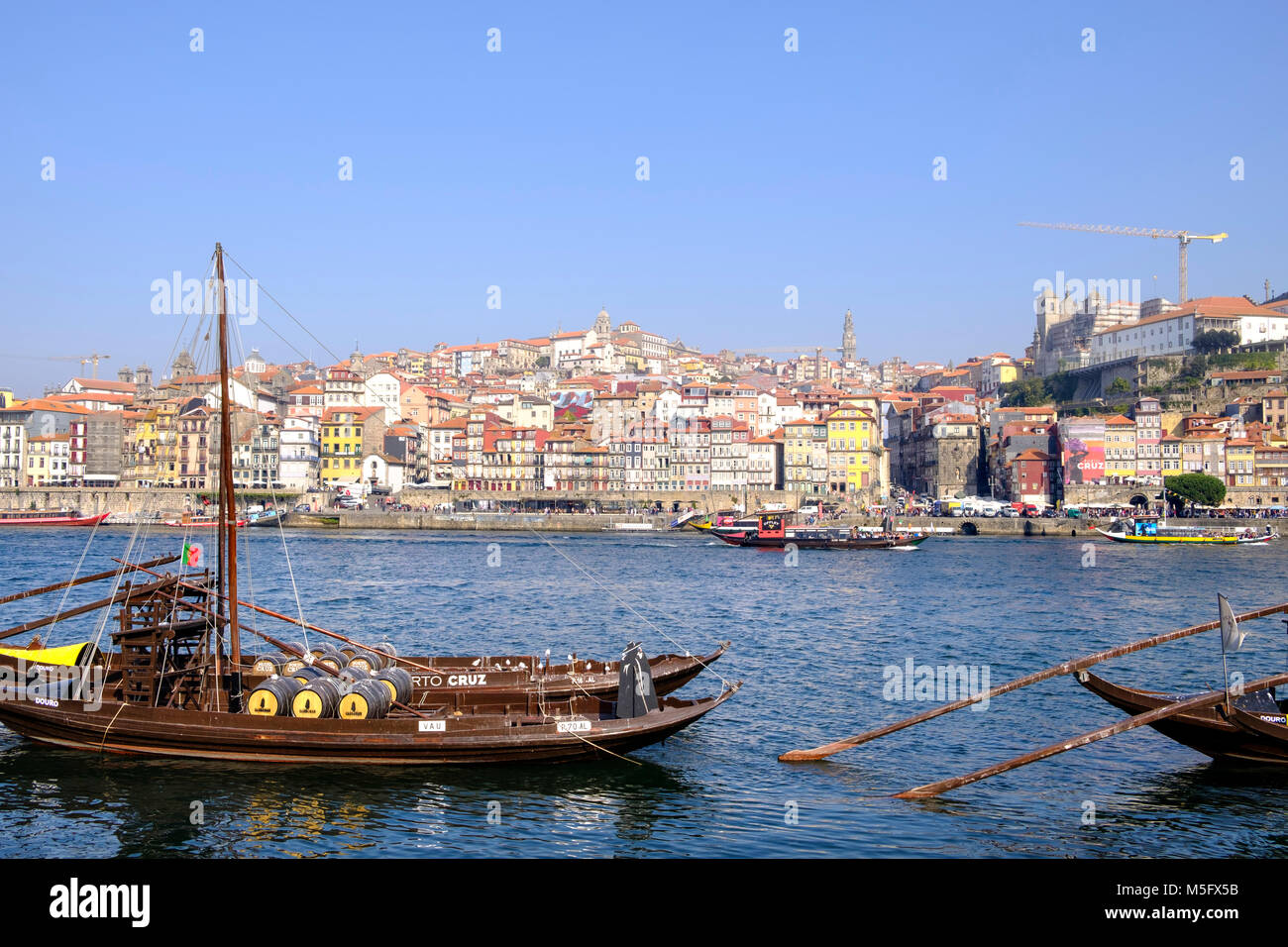 Douro River waterfront in Gaia with Barrio La Ribeira across river and Rabelo Boats, Porto, Porto Region, Portugal Stock Photo