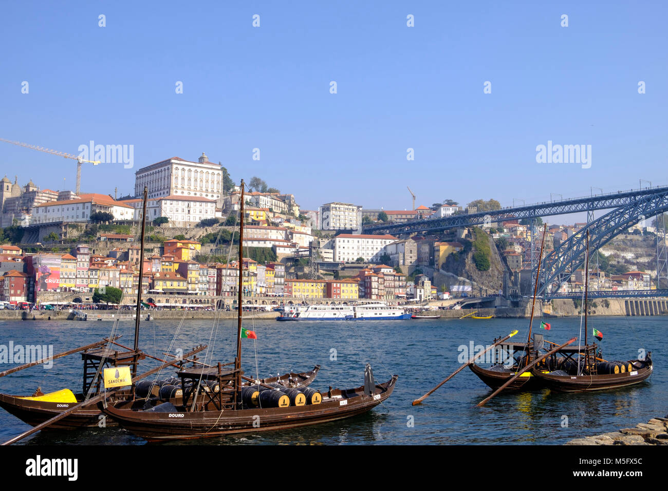 Douro River waterfront in Gaia with Barrio La Ribeira across river and Rabelo Boats, Porto, Porto Region, Portugal Stock Photo