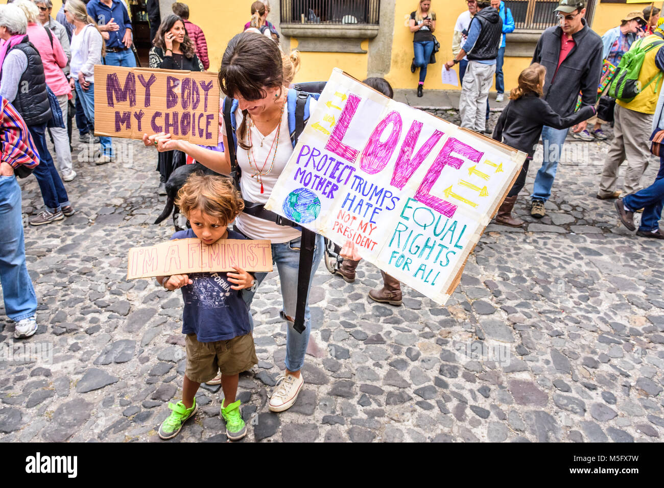 Antigua, Guatemala - January 21, 2017: Boy & mother in peaceful Women's March as part of global protest protecting women's rights & other causes Stock Photo