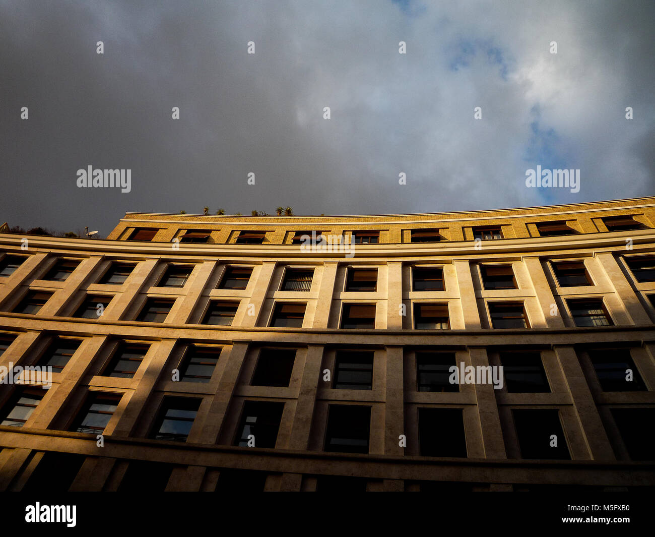 Rome, Italy: A building is illuminated by rays of sunlight before the storm Stock Photo