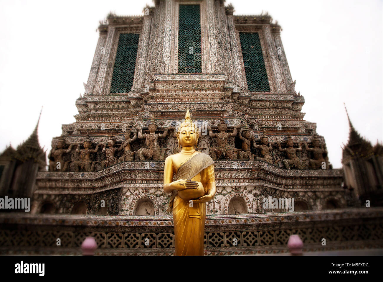 Greated by a Buddha at Wat Arun on the Choa Phraya River.  Bangkok, Thailand. Stock Photo