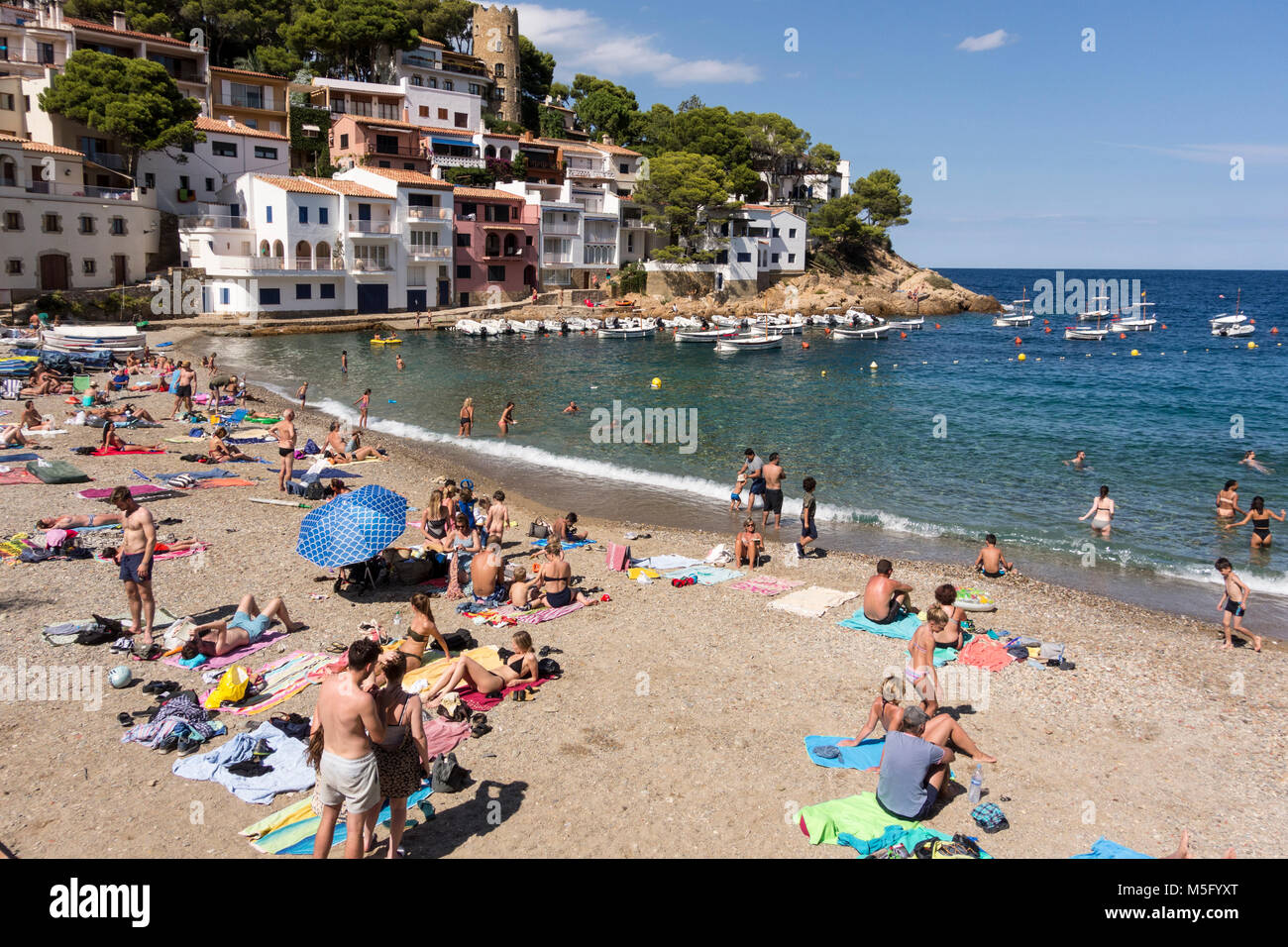 Holidaymakers on the beach at Cove of Sa Tuna, Begur, Baix d'Emporda, Costa Brava, Catalonia, Spain Stock Photo