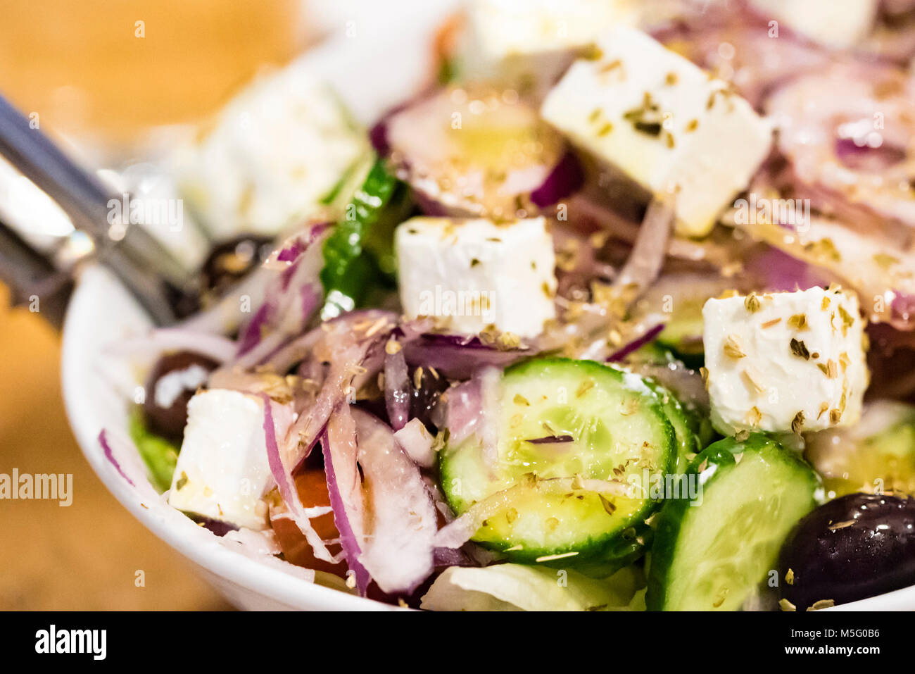 Fresh salad closeup, healthy food. Greek salad with feta cheese, macro food. Stock Photo