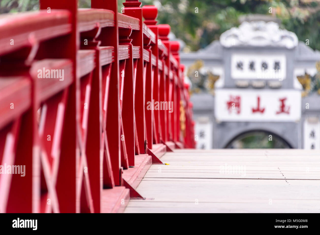 The iconic red painted Huc Bridge over Ho Hoan Kiem Lake, Hanoi, Vietnam which leads to the Den Ngoc Son Confucious Temple. Stock Photo