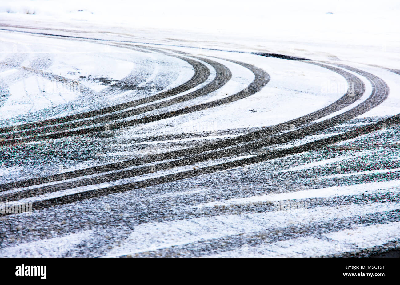 car tire track on snow in the winter road Stock Photo