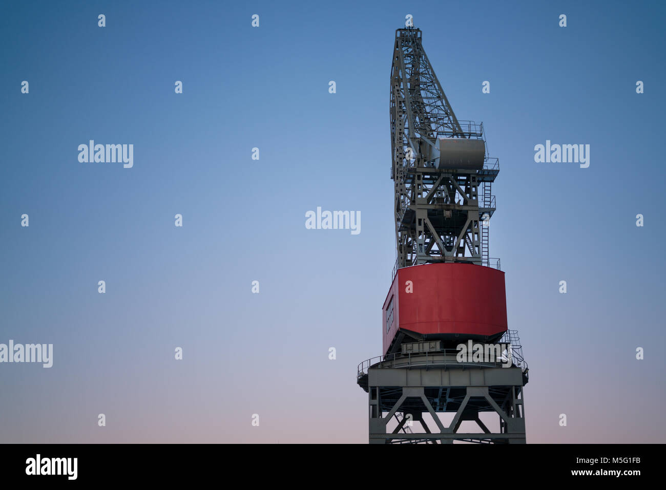 Isolated tower crane against blue sky Stock Photo
