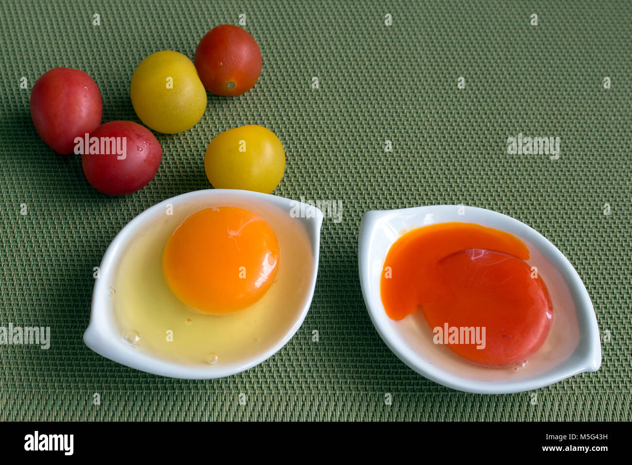 Two raw eggs with orange and red yolk Stock Photo Alamy
