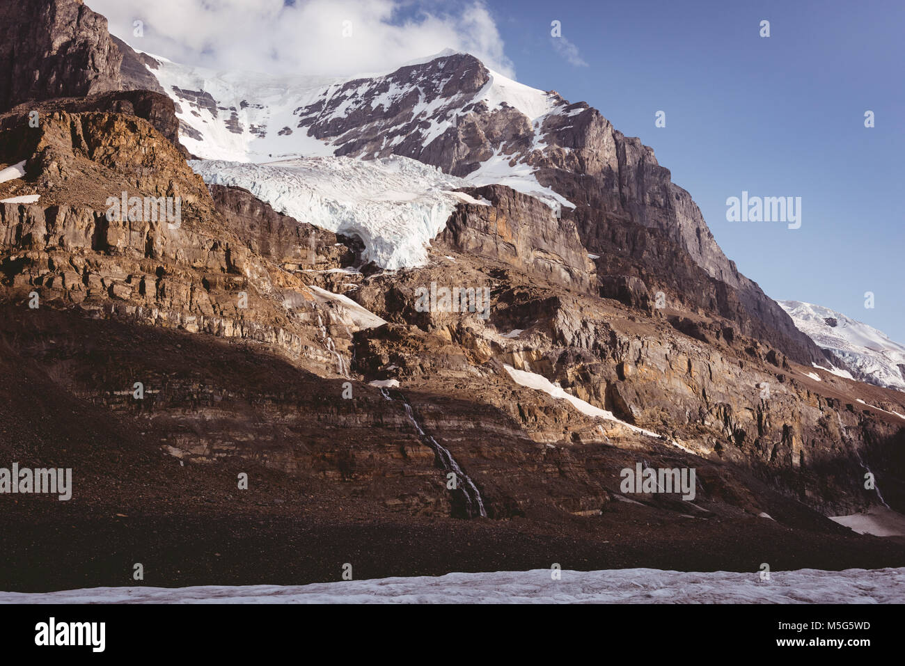 Snow capped mountains on a sunny day Stock Photo - Alamy