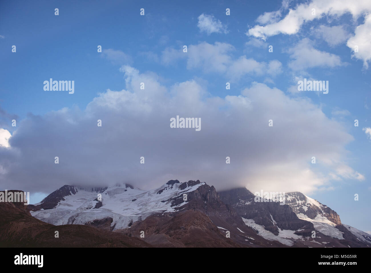 Snow capped mountains on a sunny day Stock Photo - Alamy