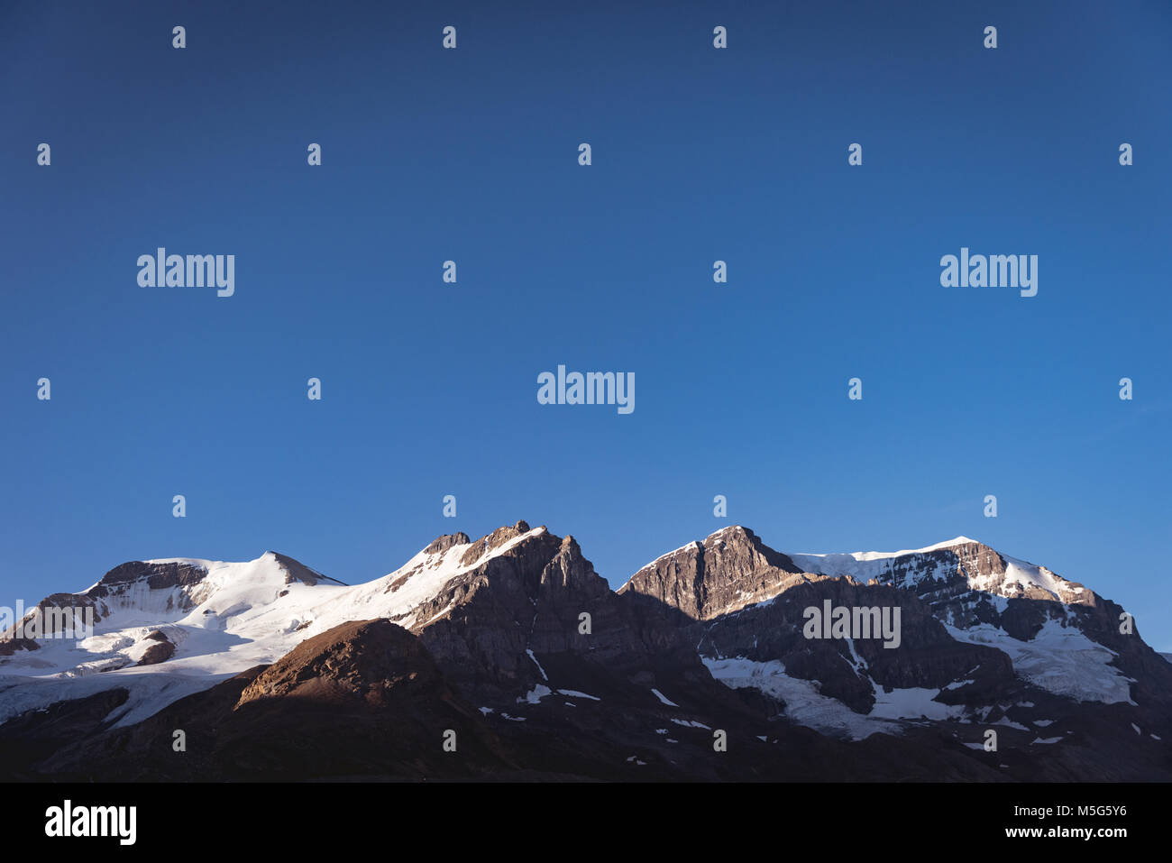 Snow capped mountain on a sunny day Stock Photo - Alamy