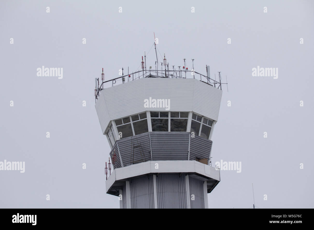 Observe airport tower in cloudy sky Stock Photo