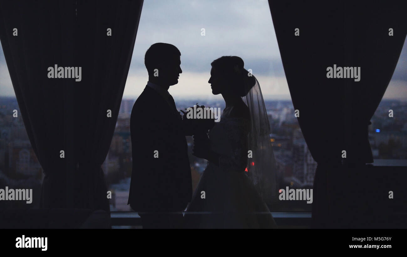 Silhouettes of the bride and groom on the background the city Stock ...