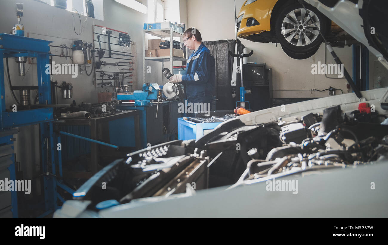 Mechanic in the garage, car preparing for professional diagnostics Stock Photo