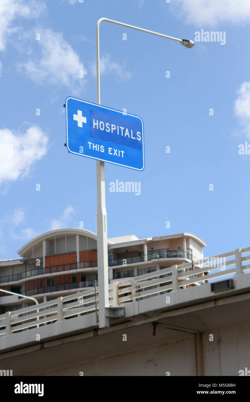 Road sign showing hospital exit on bridge, Brisbane river, Australia Stock Photo