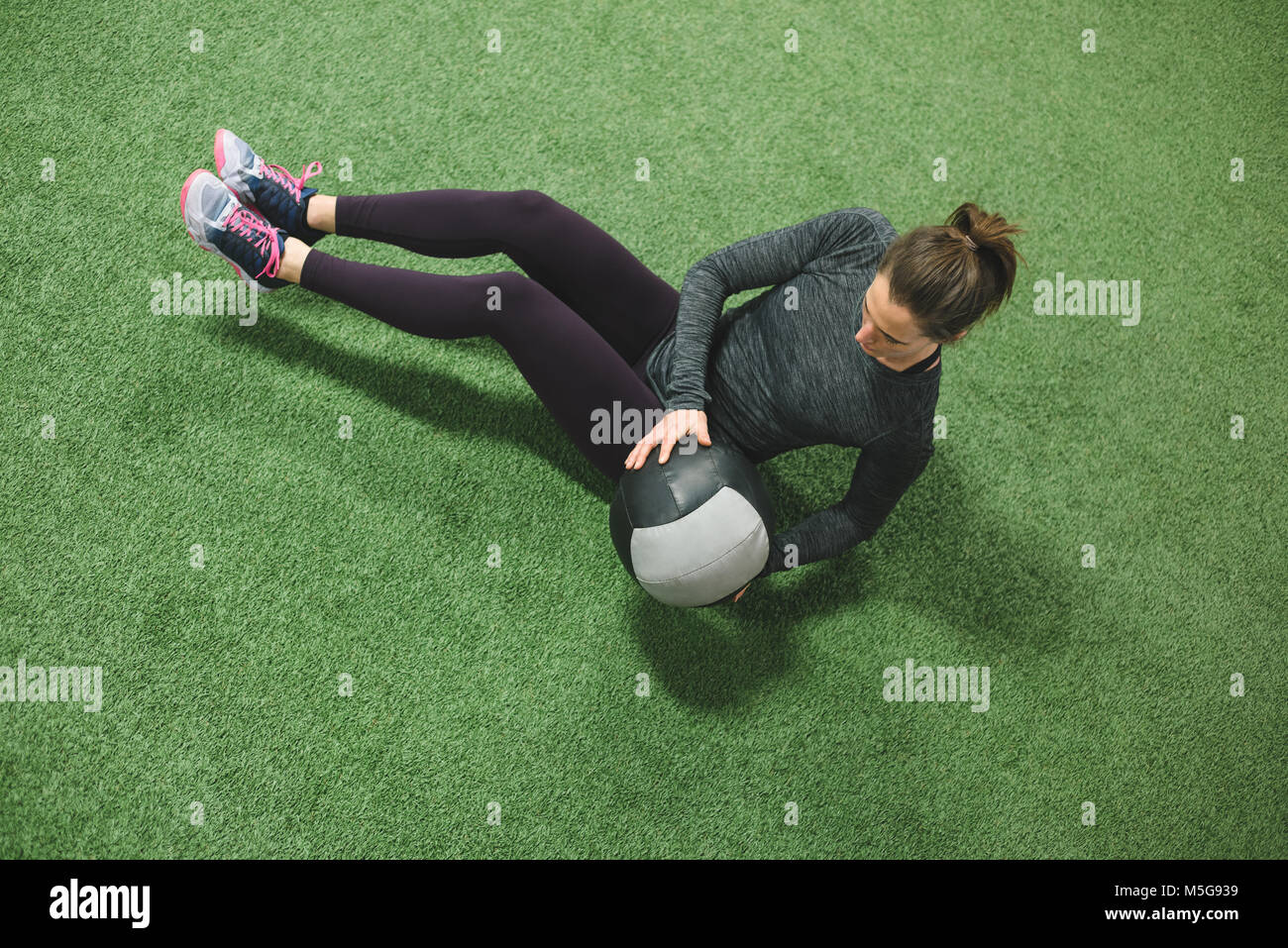 Woman practicing stretching with a ball Stock Photo - Alamy