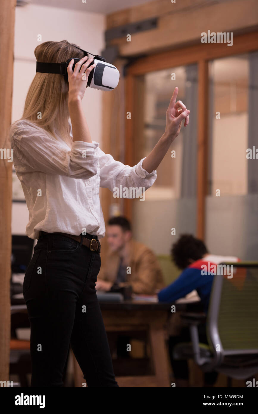 Female executive using virtual reality headset Stock Photo - Alamy