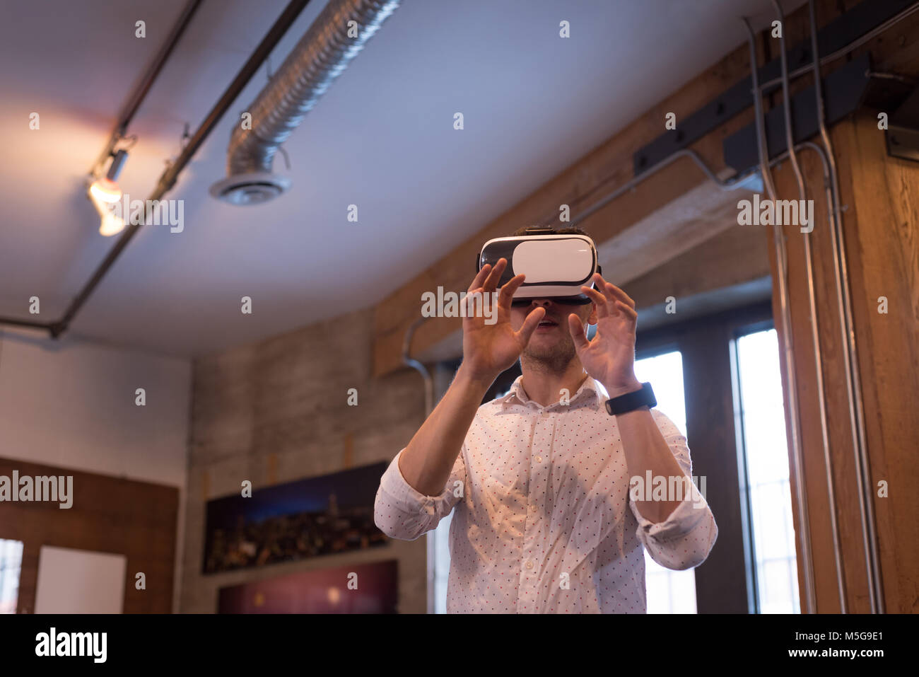 Male executive using virtual reality headset Stock Photo - Alamy