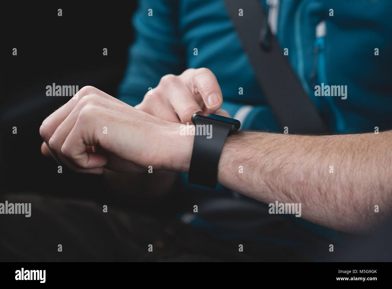 Man using smartwatch in a car Stock Photo - Alamy
