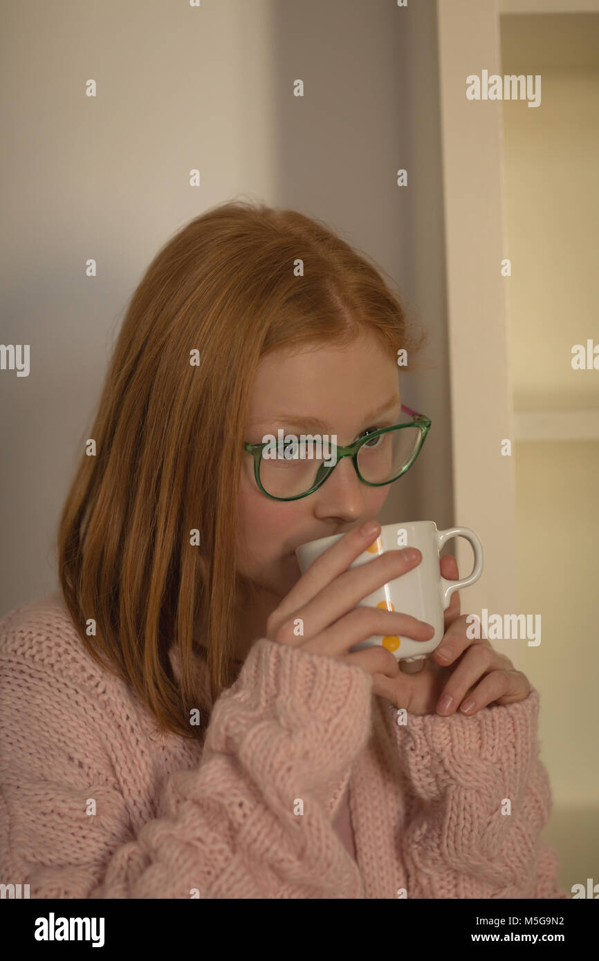 Girl having coffee at home Stock Photo