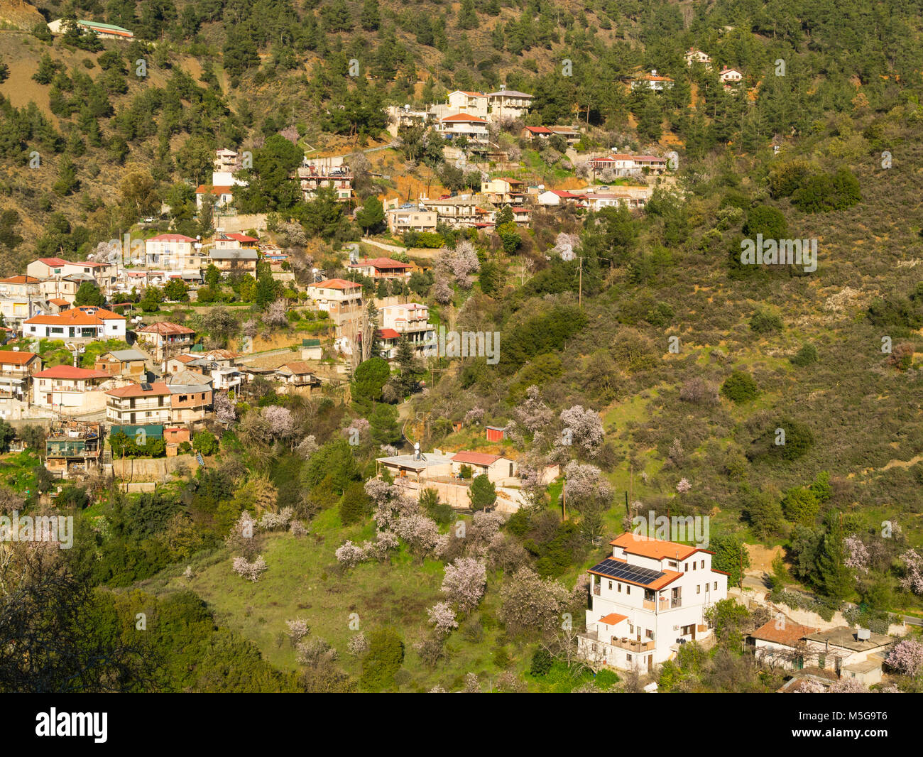 View across to tranquil and picturesque hillside Oikos Village in the Marathassa Valley Cyprus Stock Photo