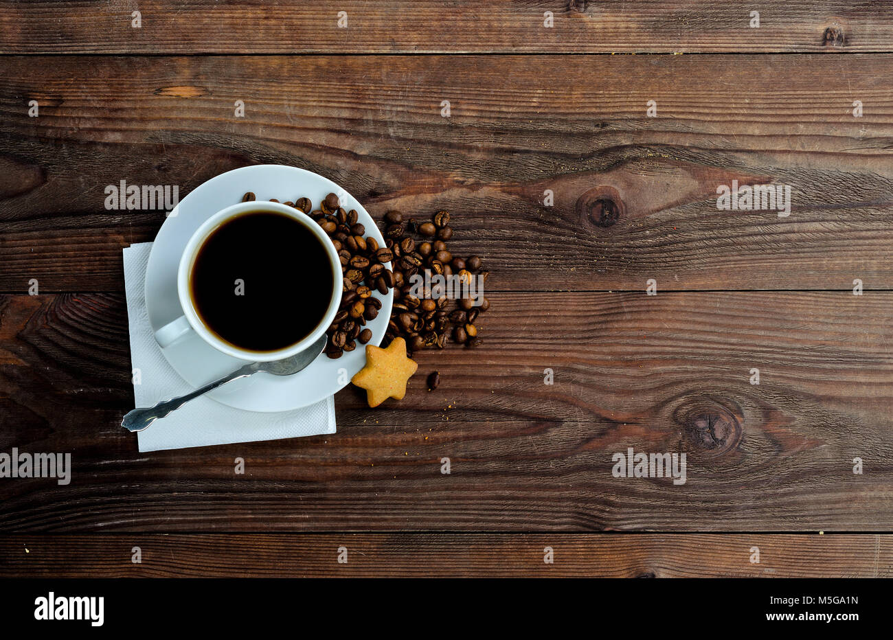 A cup of coffee, coffee beans and one star cookies Stock Photo