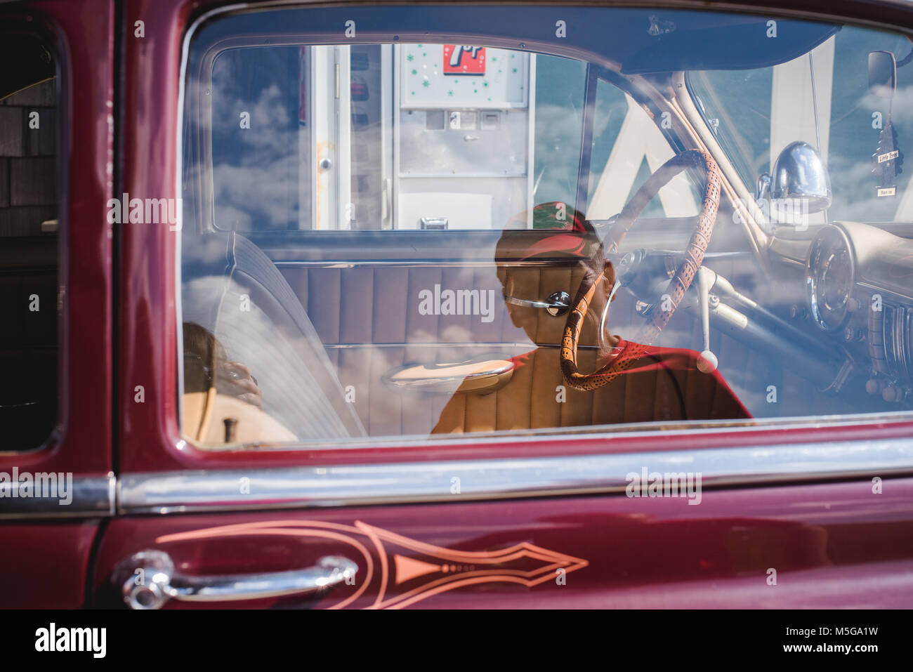 The reflection of a man in the window of a vintage Chevy car. Stock Photo