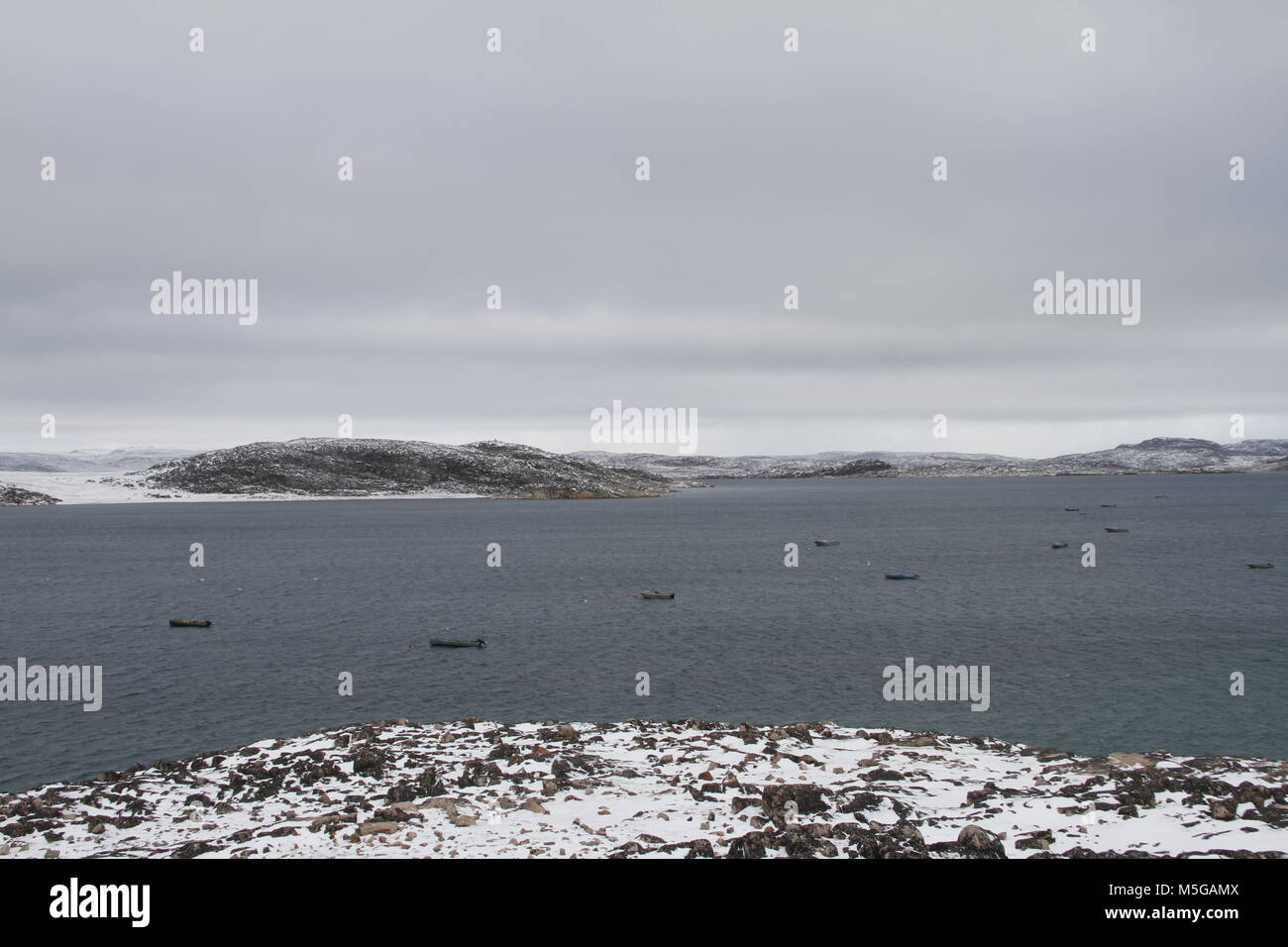 View of Cape Dorset (Kinngait) Nunavut with a view of the ocean and boats, a northern Inuit community in arctic Canada Stock Photo