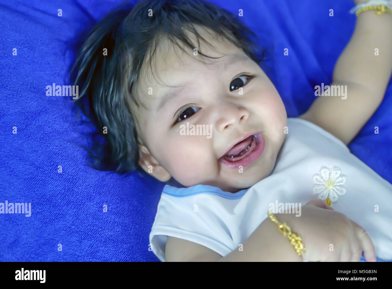 Asian cute baby girl lying on the bed Stock Photo