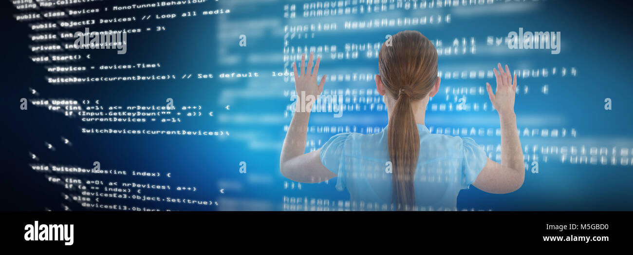 Composite image of rear view of businesswoman using imaginary screen Stock Photo