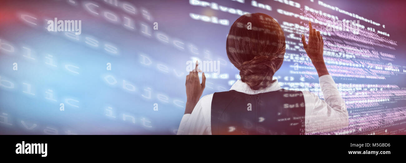 Composite image of rear view of businesswoman using interface Stock ...