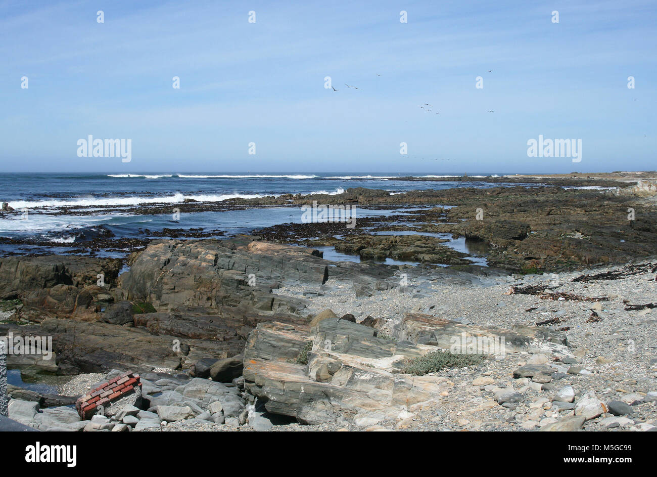 View of the rocky coastline of Robben Island, Cape Town, South Africa Stock Photo