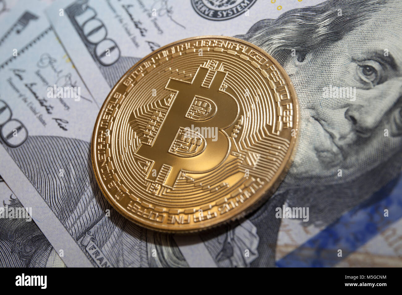 golden bitcoin coin on us dollars top view Stock Photo - Alamy